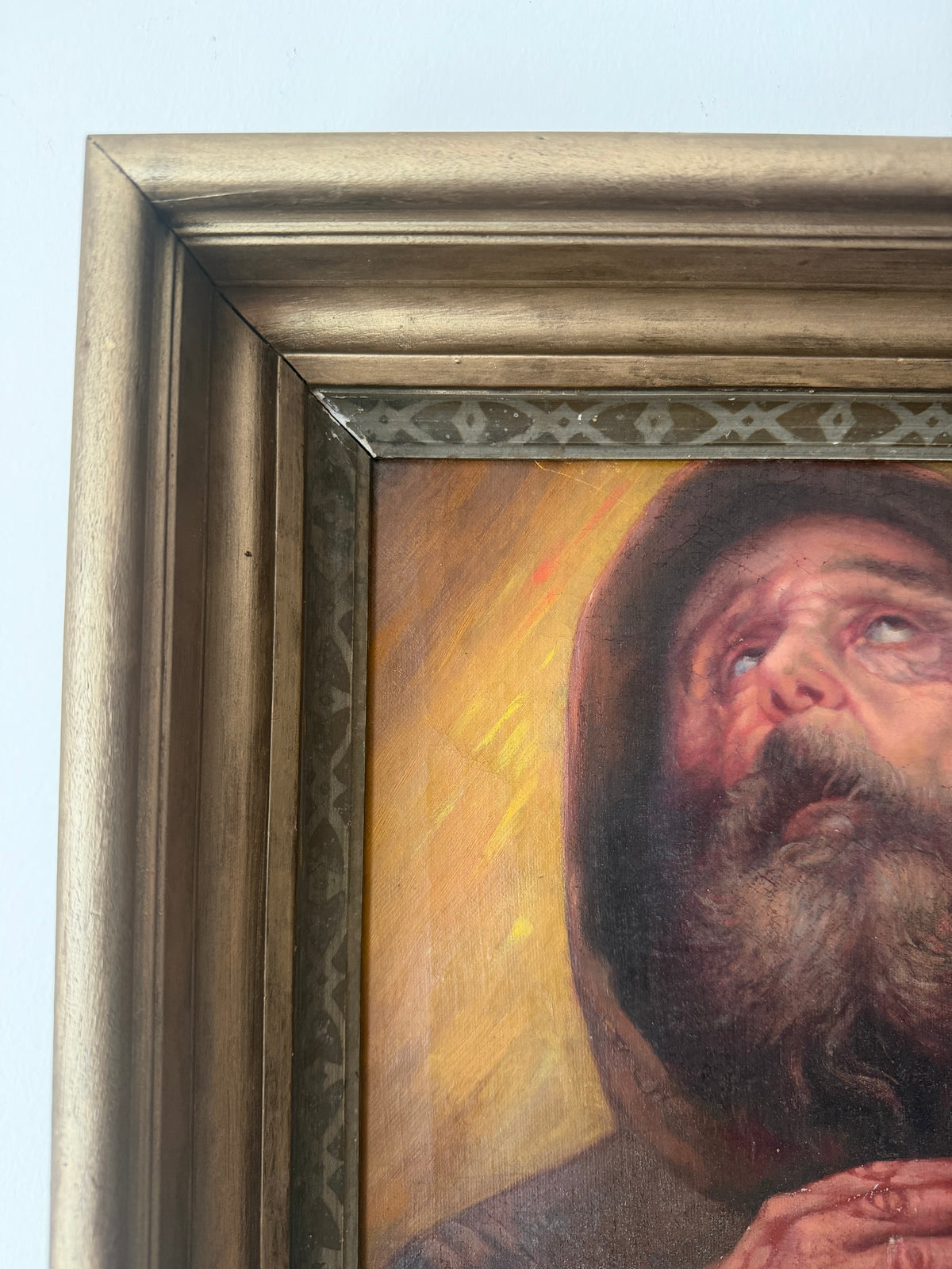 Detail showing an additional blemish on the antique carved wood frame
