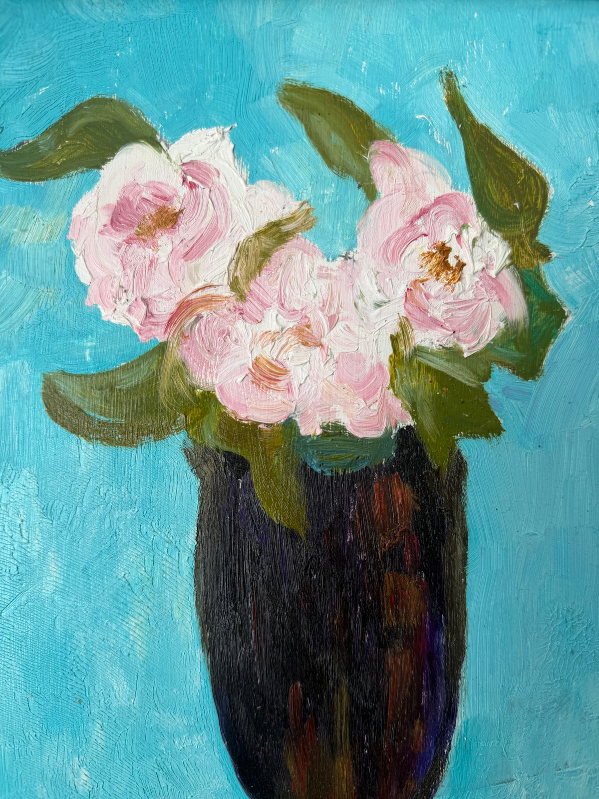 Detail of soft pink roses against the brilliant blue background of a vintage floral painting