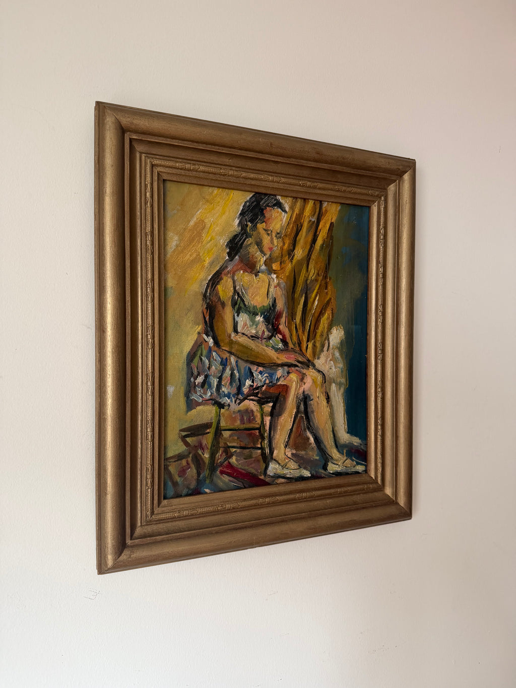 Angled view of Pensive Ballerina displayed in its vintage gilt wood frame