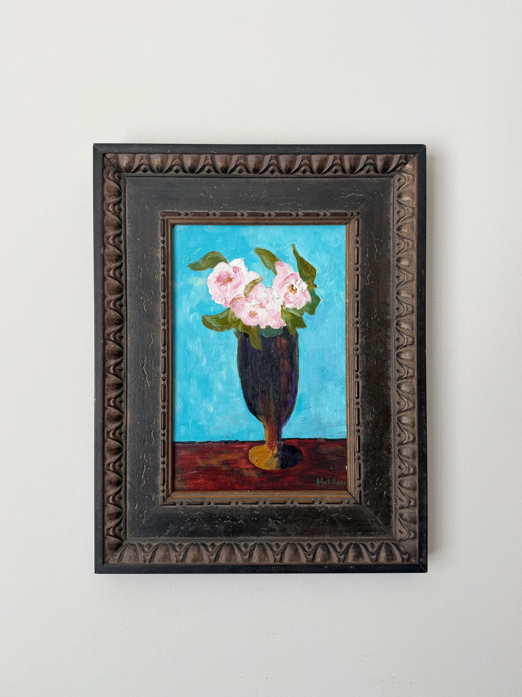 Original vintage floral still life painting of pink roses in a dark vase against a vivid blue background