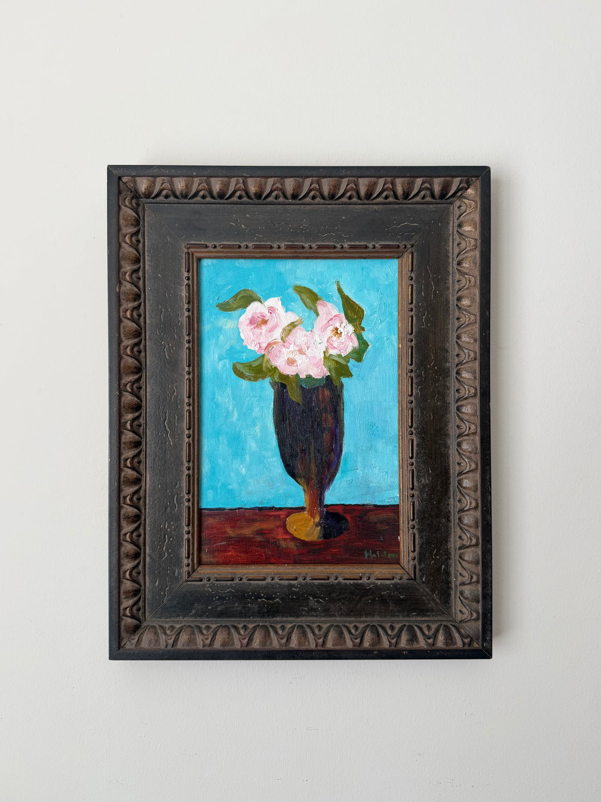 Original vintage floral still life painting of pink roses in a dark vase against a vivid blue background