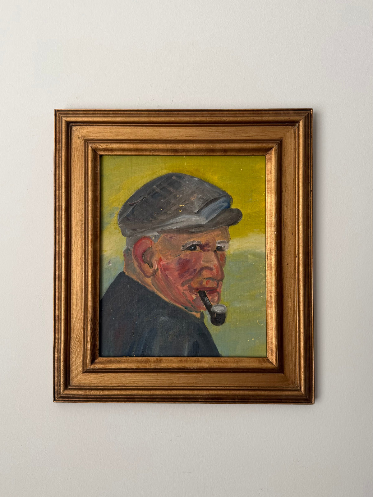 Original vintage oil portrait of a man in a cap smoking a pipe, displayed in a gilt wood frame