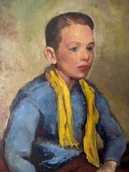 Close-up of the young boy’s thoughtful expression in the vintage portrait Boy in Blue